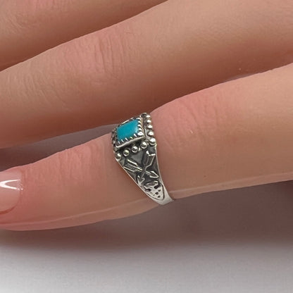 Sterling silver turquoise ring worn on mannequin hand as a pinky ring
