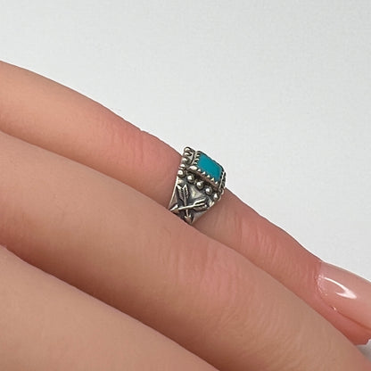 Sterling silver turquoise ring worn on mannequin hand as a pinky ring