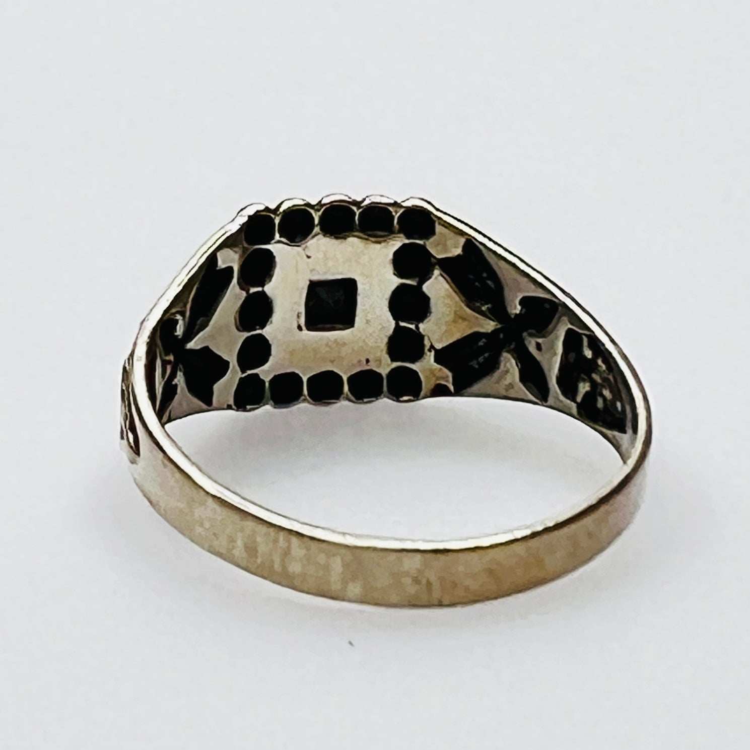 Back view of vintage turquoise ring with detailed bezel and side motifs