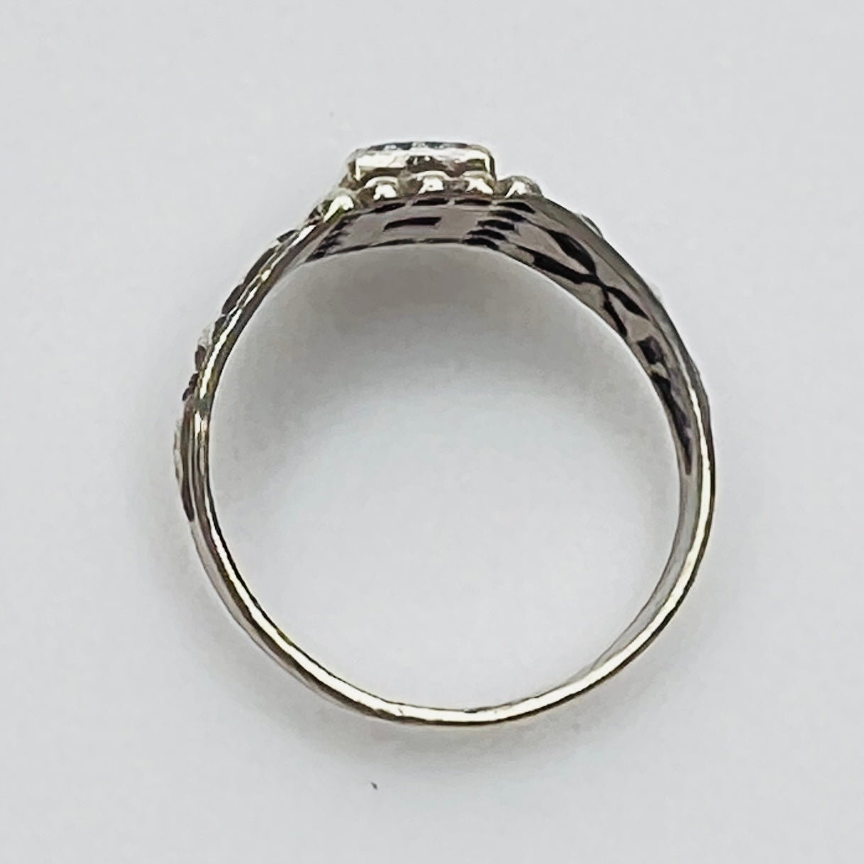 Top view of vintage turquoise ring with detailed bezel and side motifs