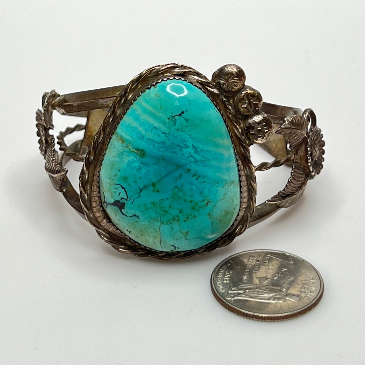 Vintage Native American turquoise and sterling silver cuff bracelet with floral motif