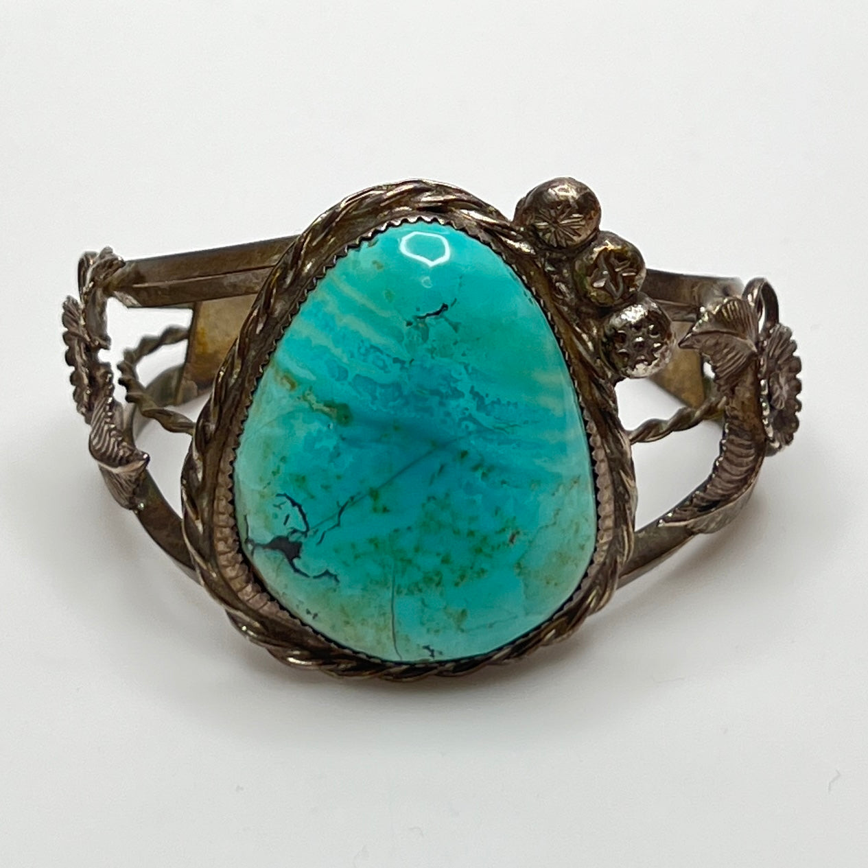 Vintage Native American turquoise and sterling silver cuff bracelet with floral motif
