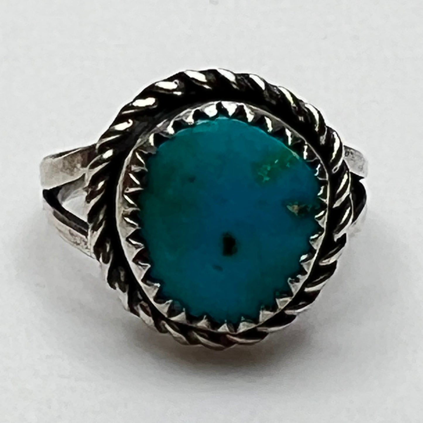 Close-up of oval turquoise stone with rope-edge bezel