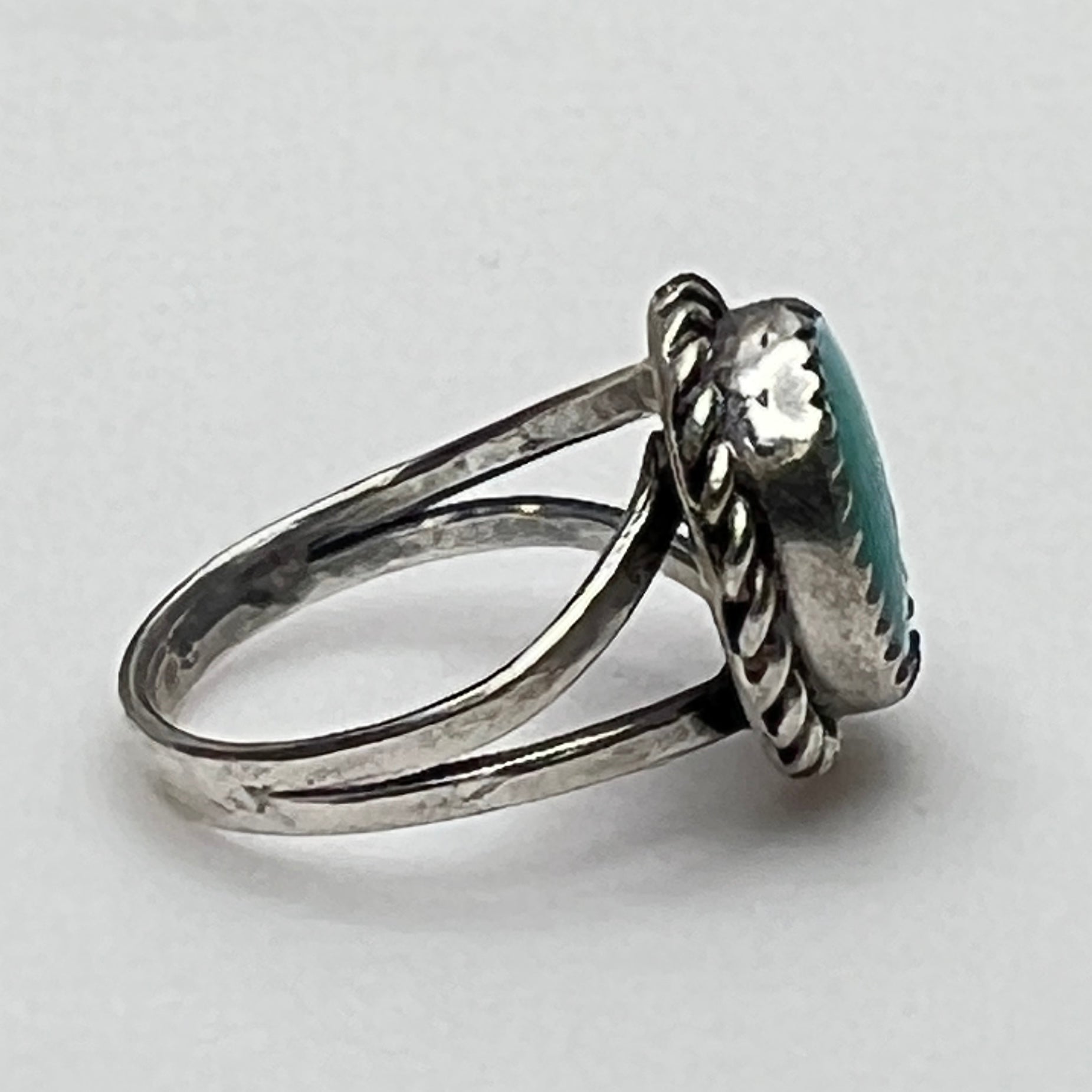 Side view of split shank turquoise ring in silver setting