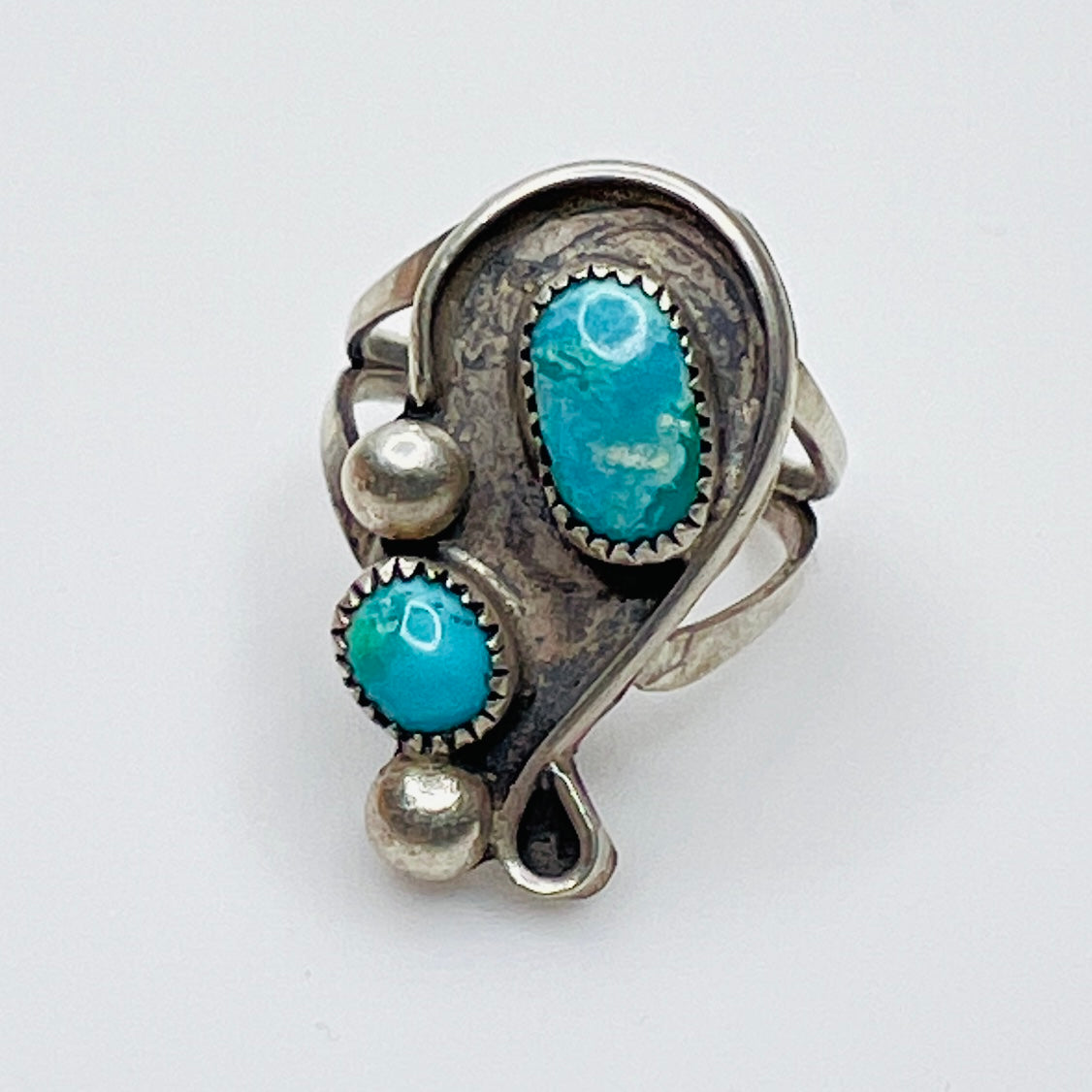 Vintage artisan turquoise ring with asymmetrical silver setting