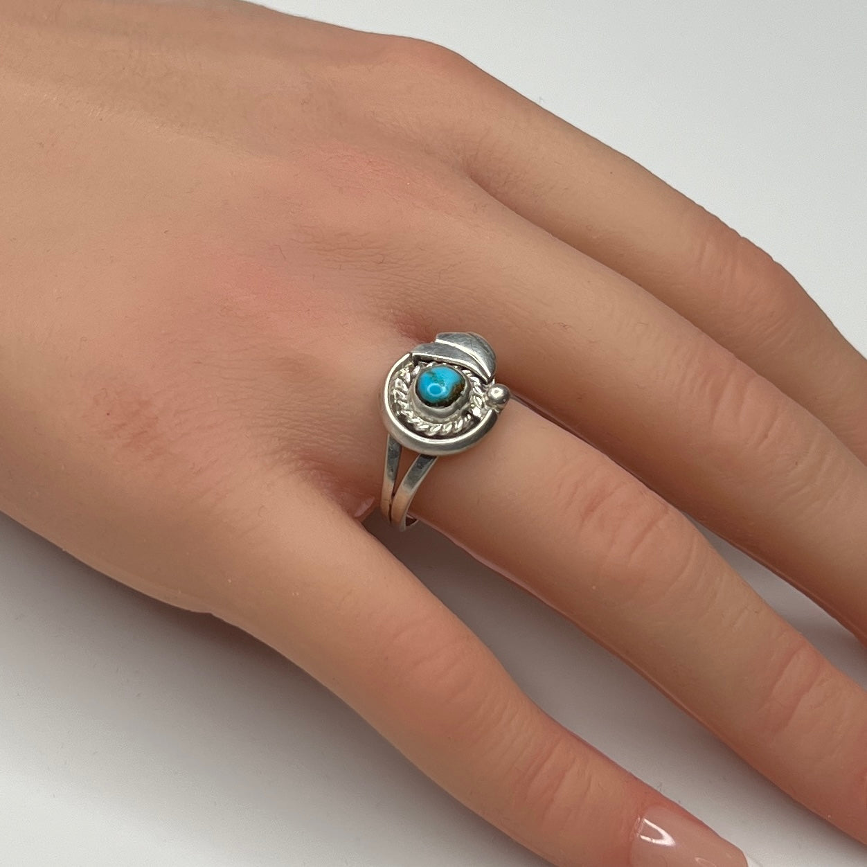 Sterling silver ring with turquoise cabochon on model hand