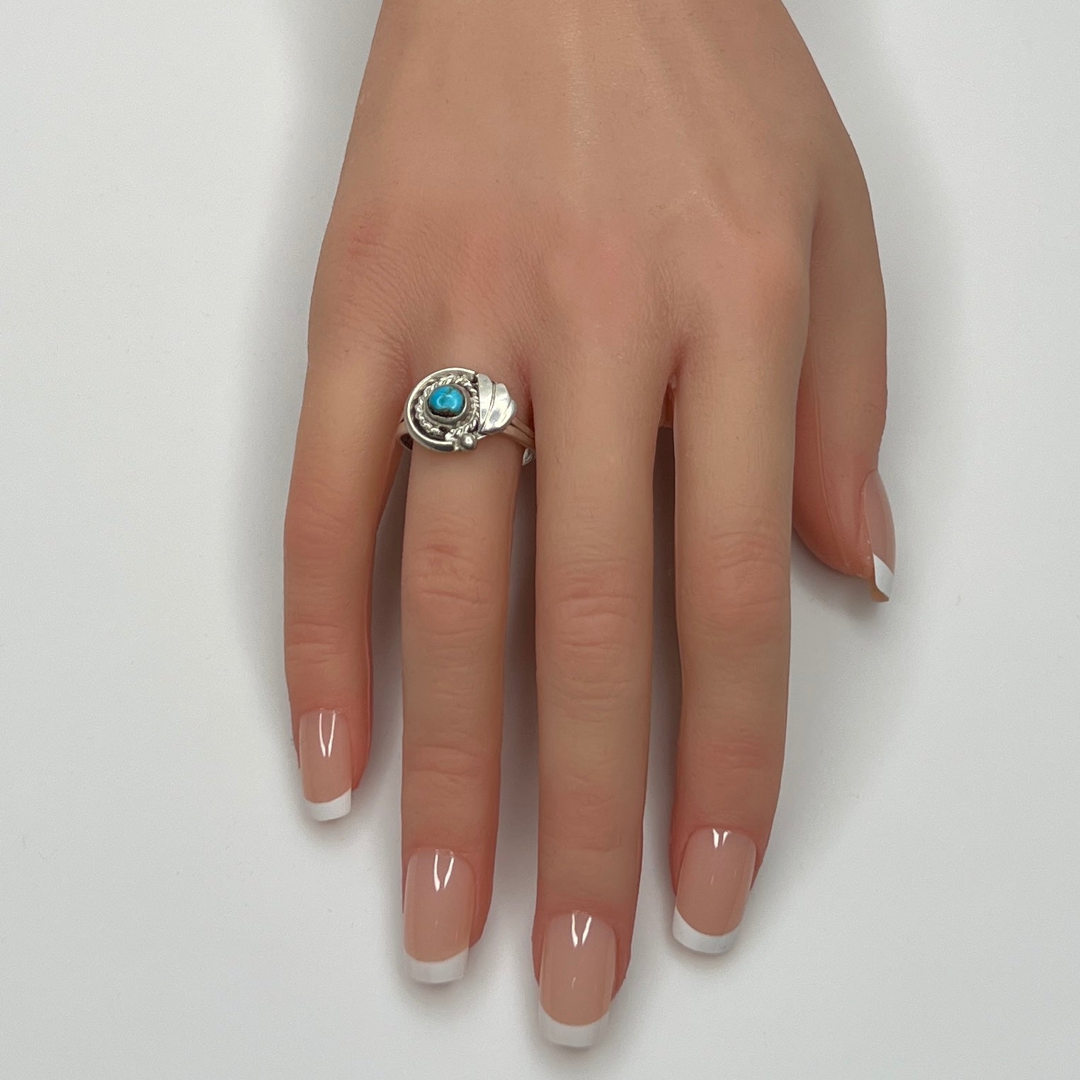 Sterling silver ring with turquoise cabochon on model hand