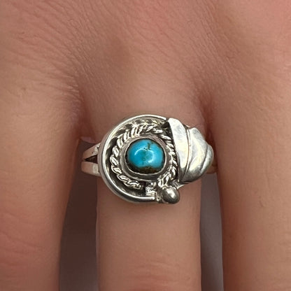 Sterling silver ring with turquoise cabochon on model hand