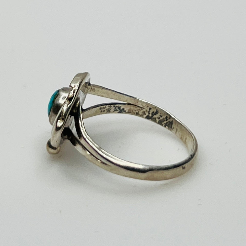 Close-up of turquoise ring showing rope and leaf motif