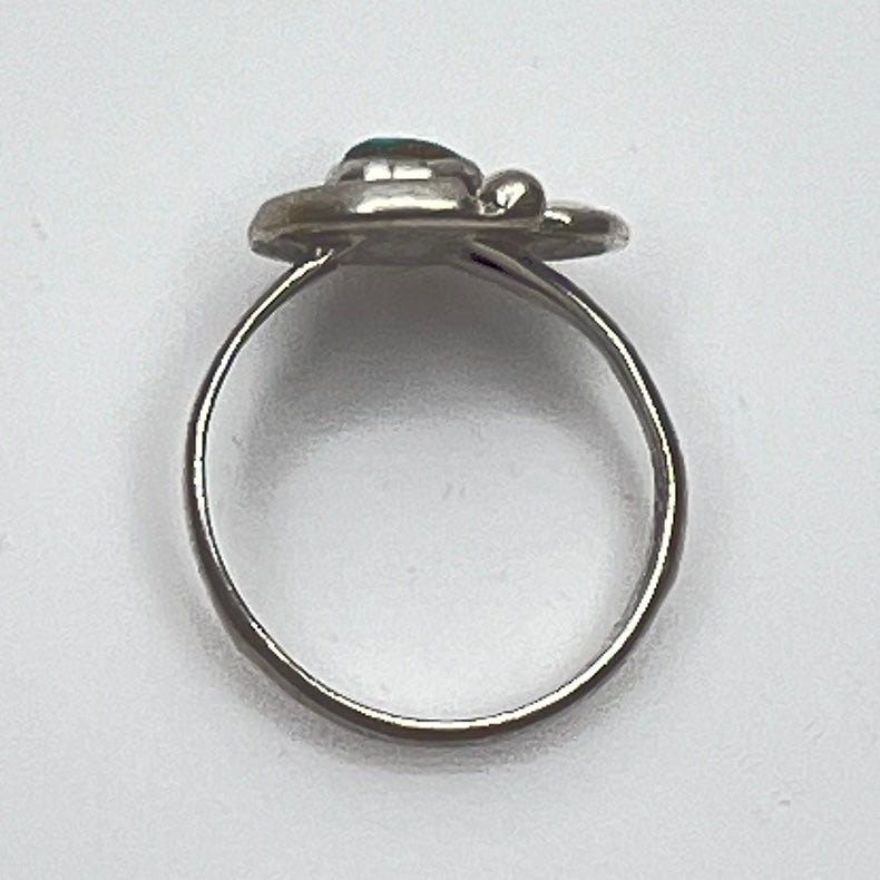 Close-up of turquoise ring showing rope and leaf motif