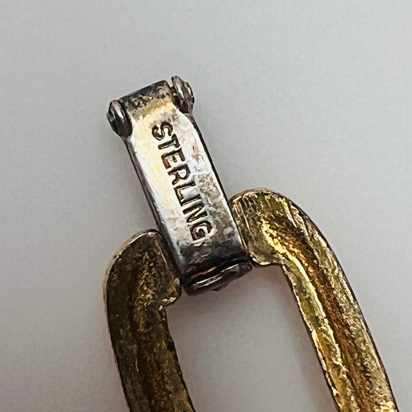 Close-up of sterling stamp on fold-over clasp