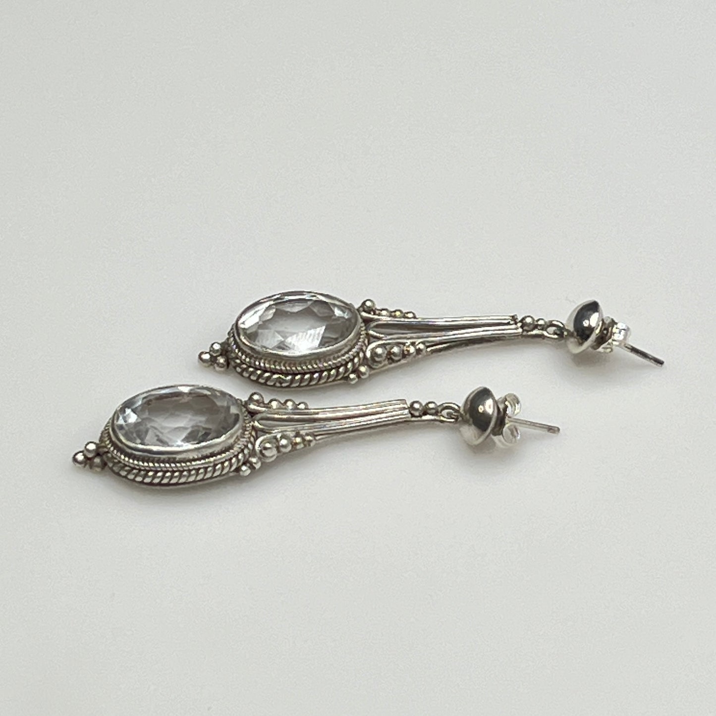 Side view of vintage silver earrings with ornate detailing