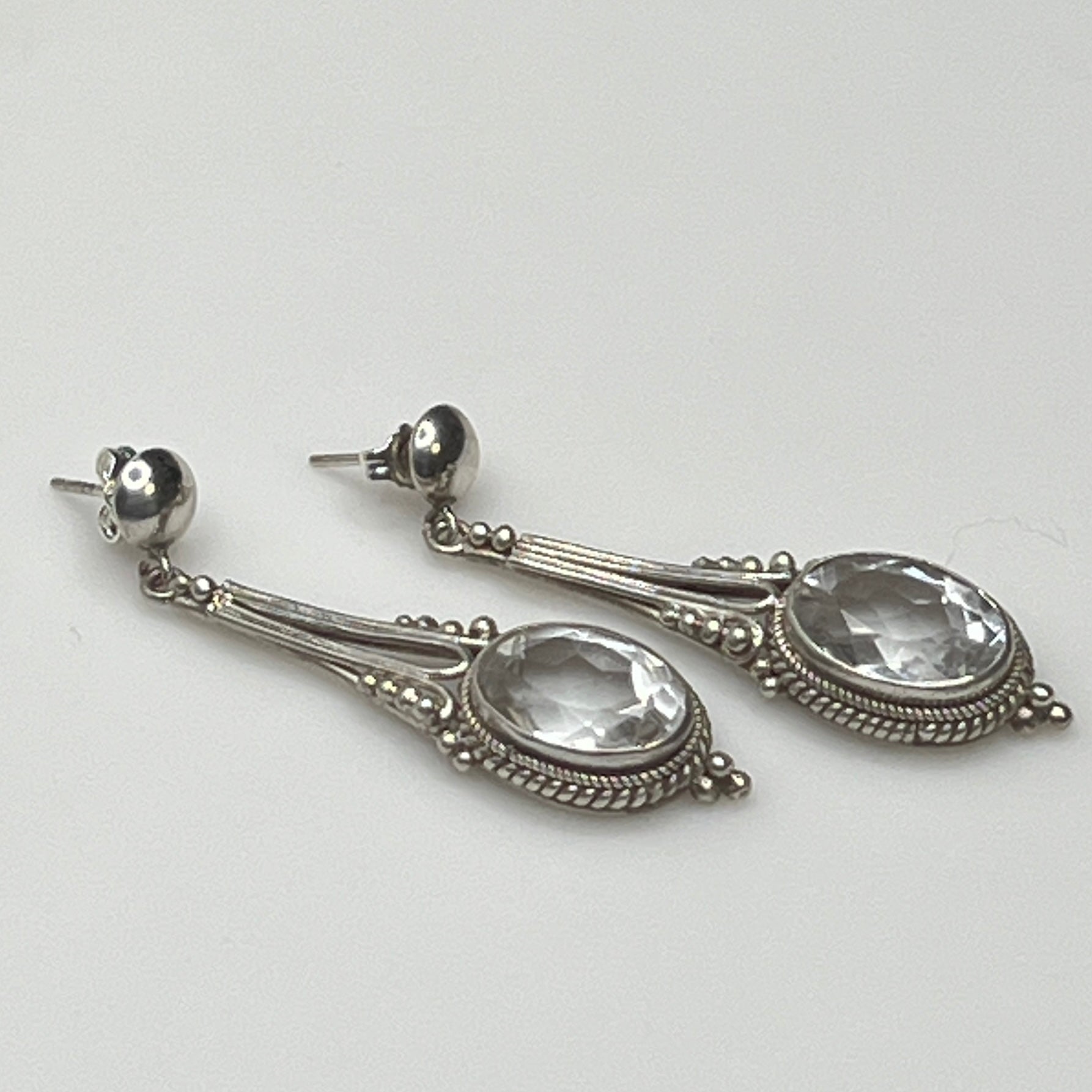 Side view of vintage silver earrings with ornate detailing