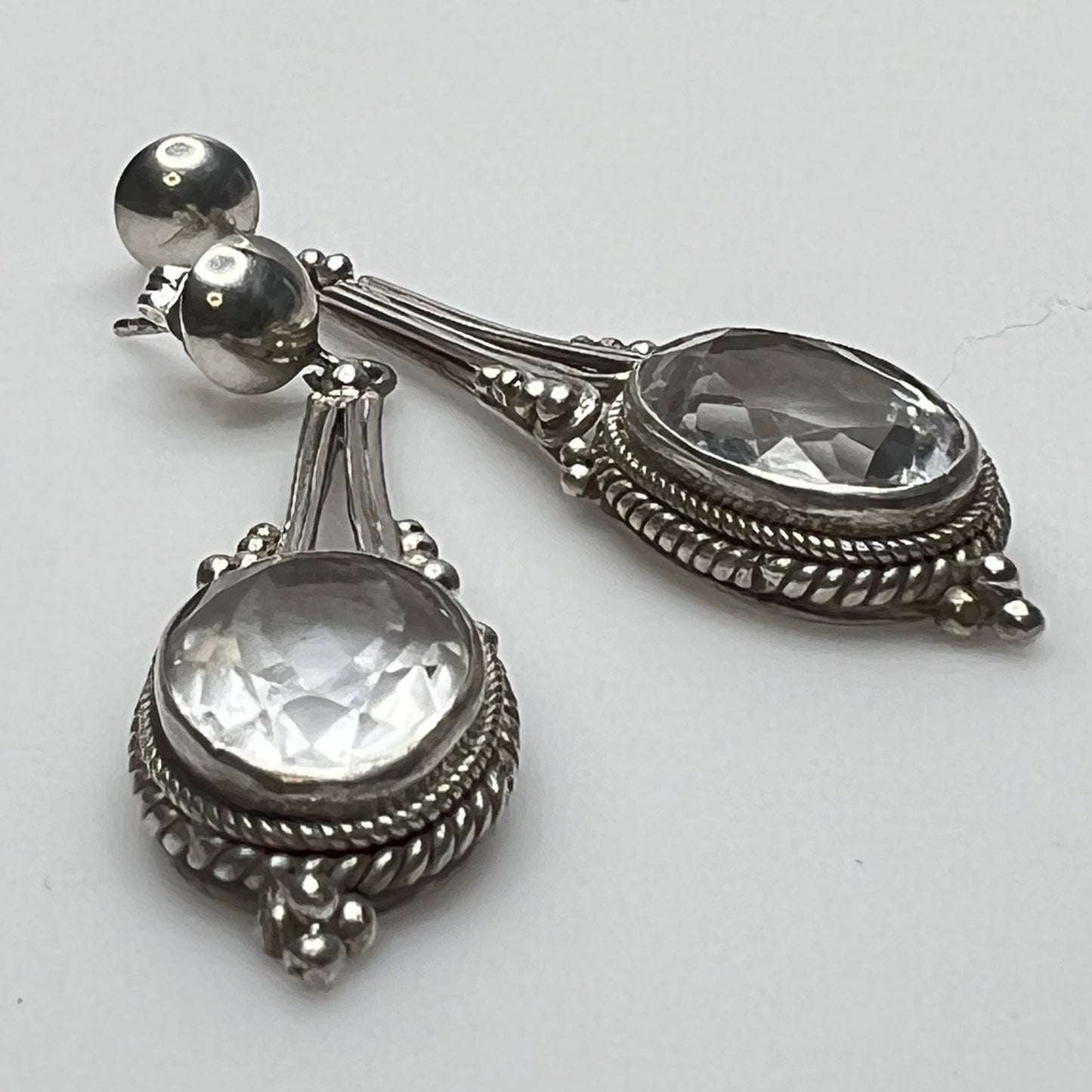 Side view of vintage silver earrings with ornate detailing
