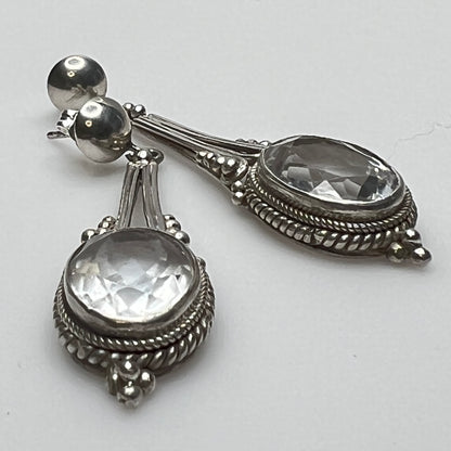 Side view of vintage silver earrings with ornate detailing