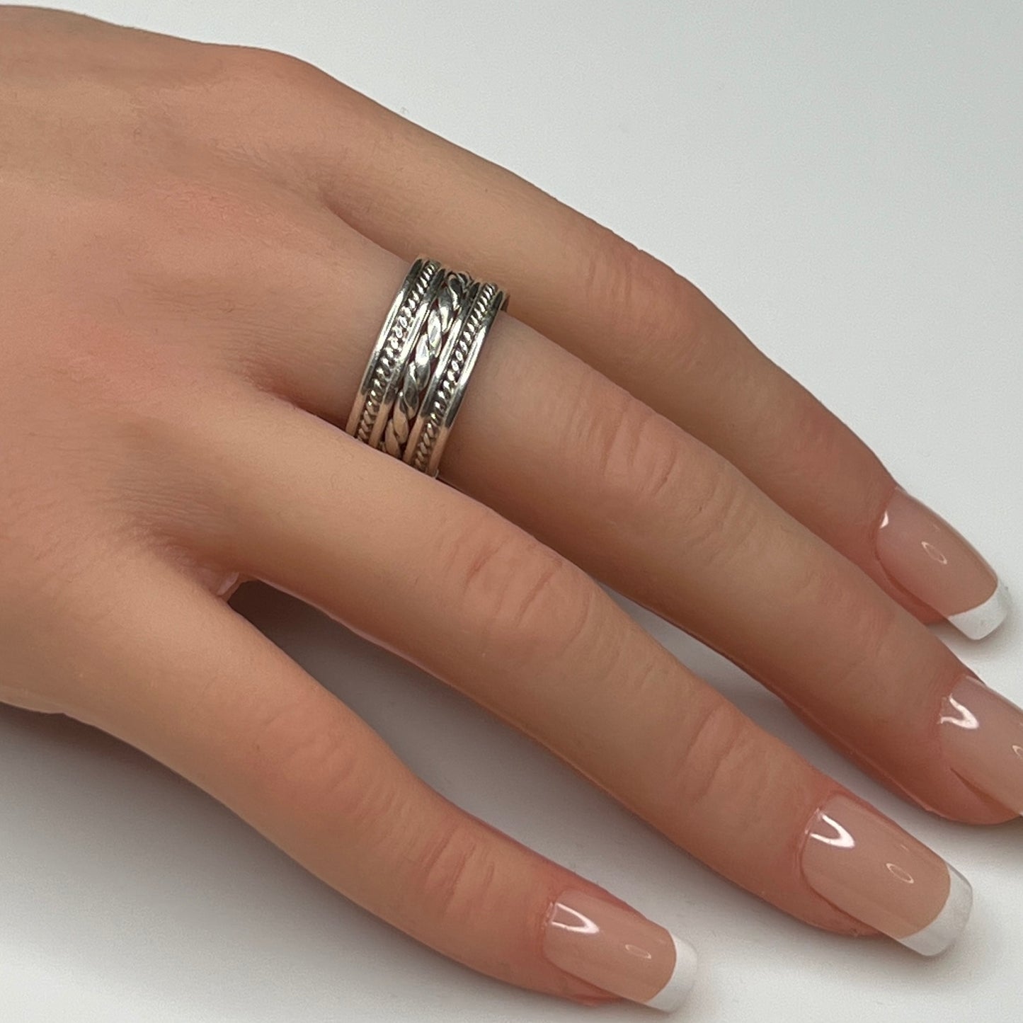 Sterling silver wide rope band ring worn on hand