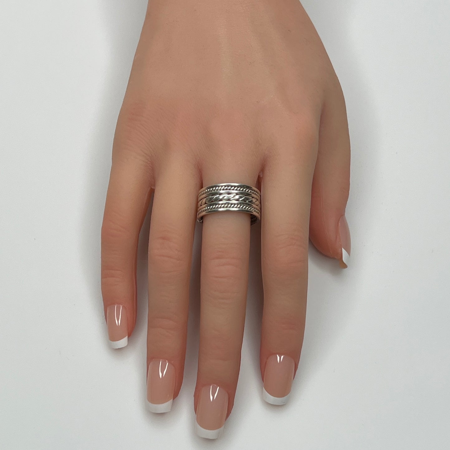 Sterling silver wide rope band ring worn on hand