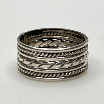 Close-up of textured braid and rope design on ring band