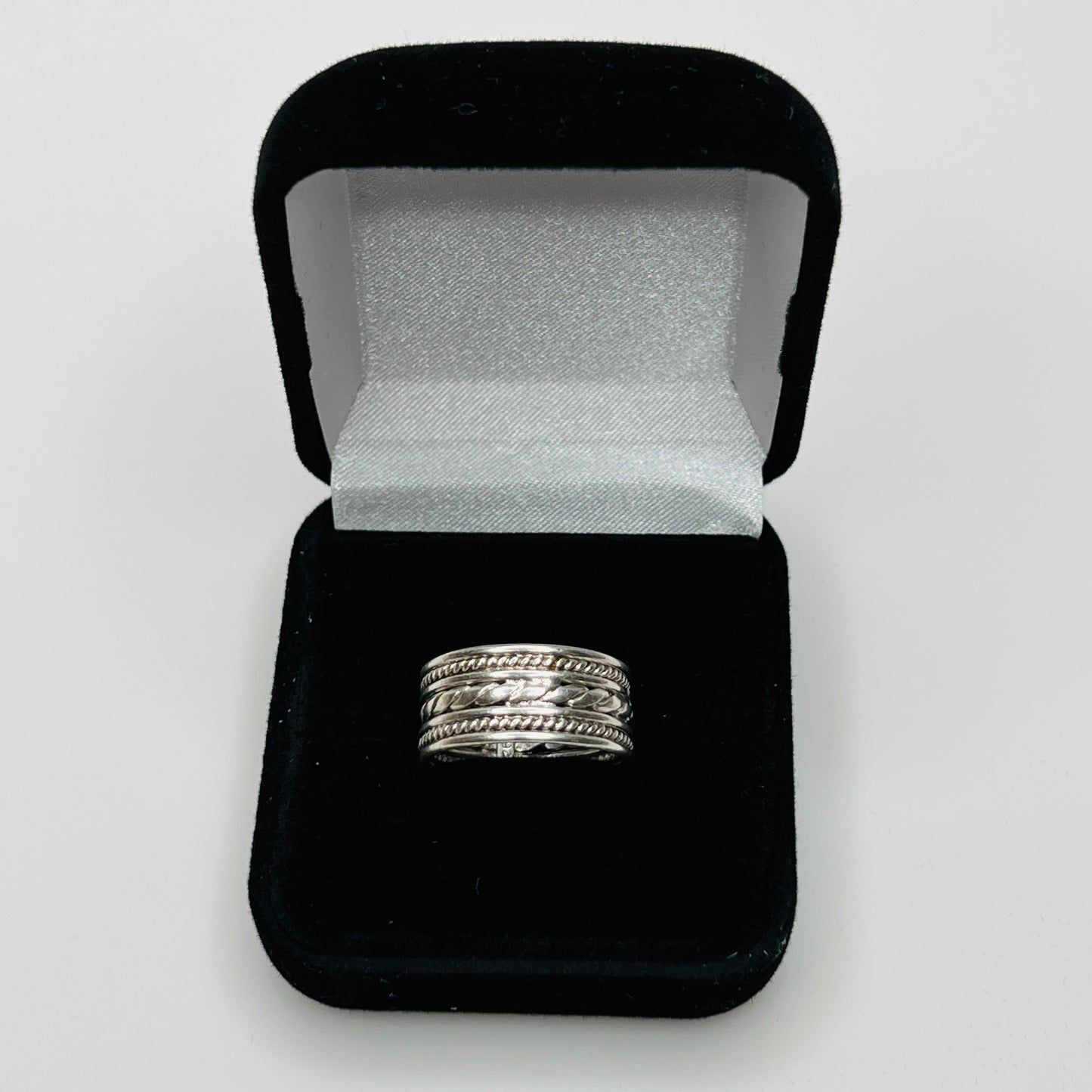 Close-up of textured braid and rope design on ring band