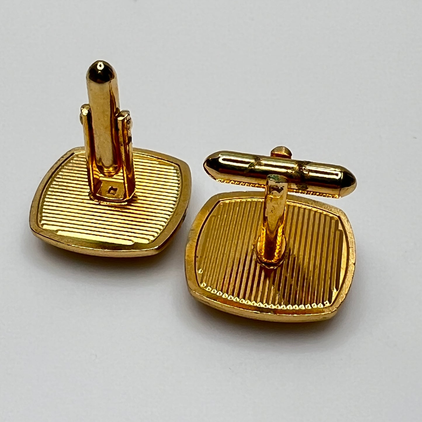 Square goldtone cufflinks with large tiger’s eye cabochons