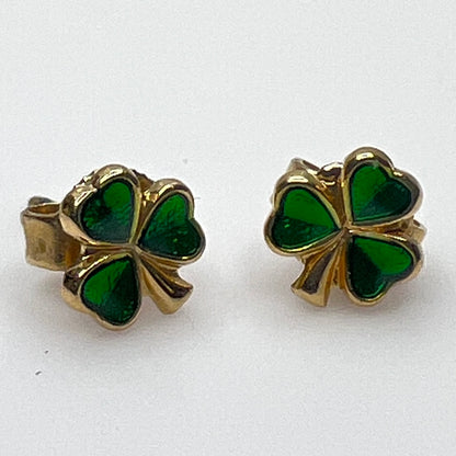 Tiny 14K gold shamrock stud earrings with green enamel cloverleaf design