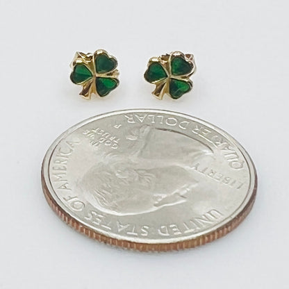Tiny 14K gold shamrock stud earrings with green enamel cloverleaf design
