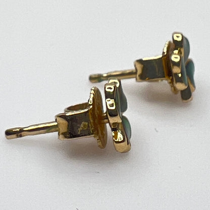 Tiny 14K gold shamrock stud earrings with green enamel cloverleaf design
