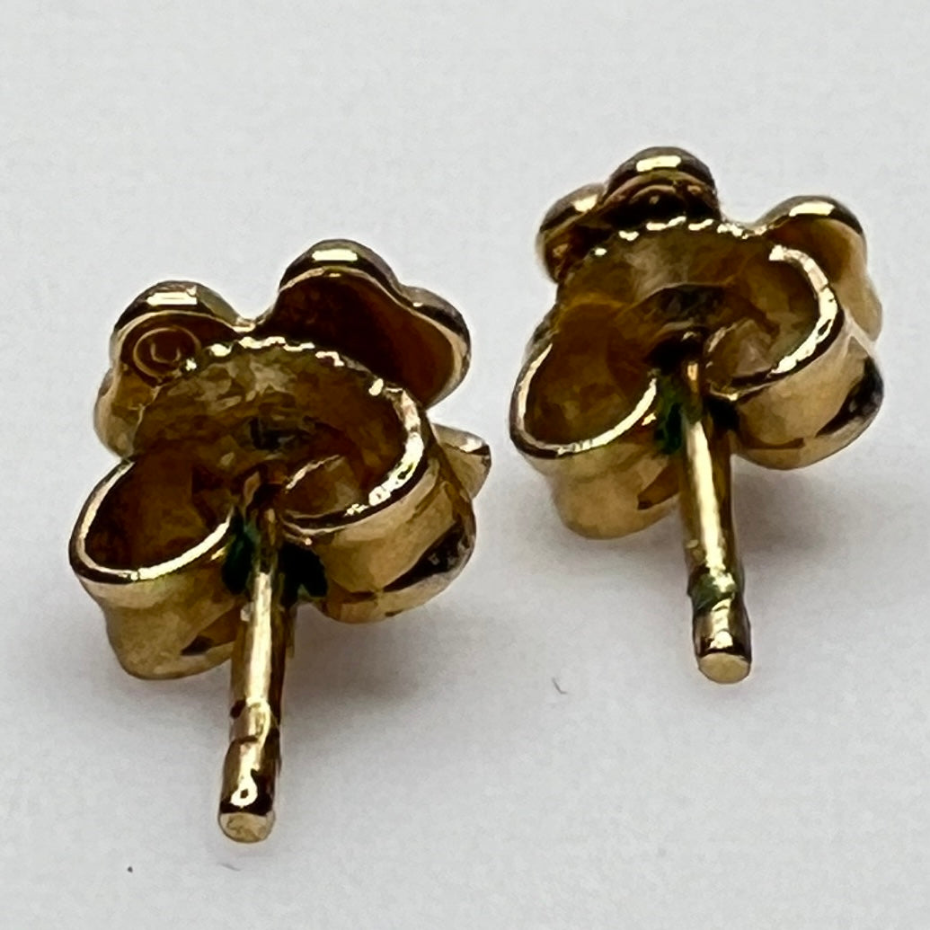 Tiny 14K gold shamrock stud earrings with green enamel cloverleaf design