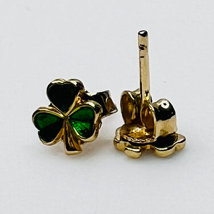 Tiny 14K gold shamrock stud earrings with green enamel cloverleaf design