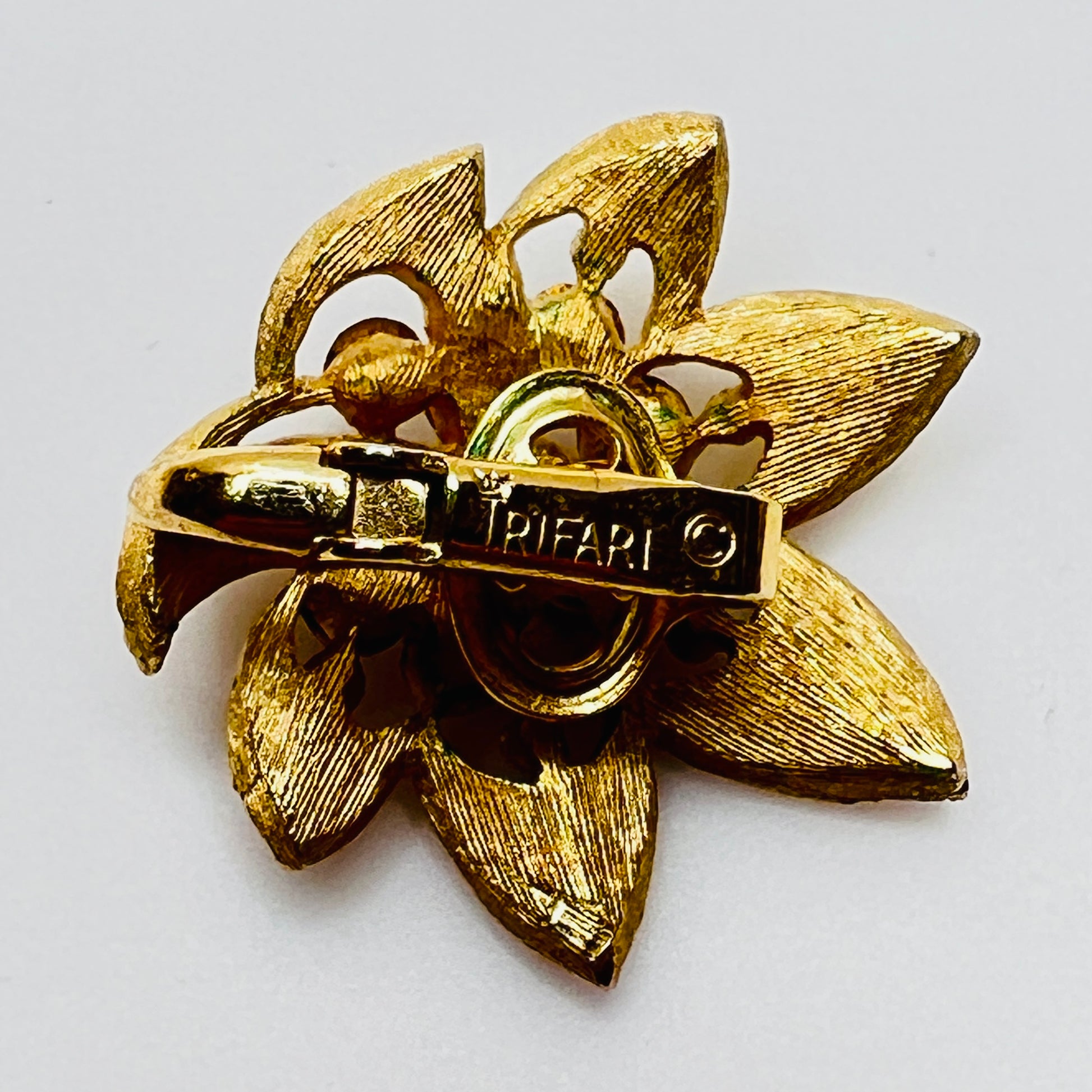 Close-up of signed Trifari flower set with starburst rhinestone details