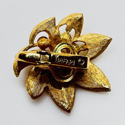 Close-up of signed Trifari flower set with starburst rhinestone details