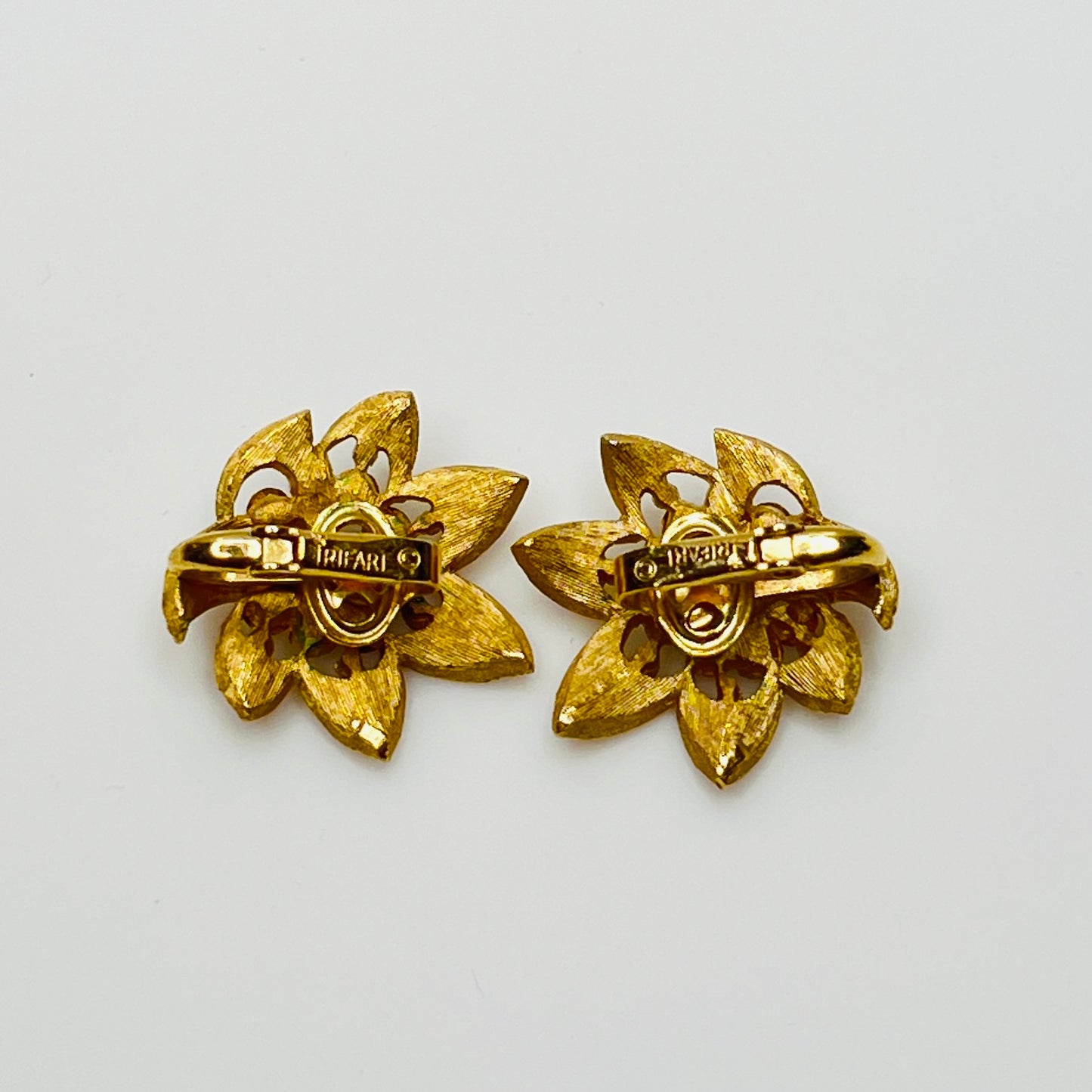 Close-up of signed Trifari flower set with starburst rhinestone details