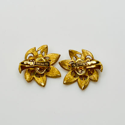 Close-up of signed Trifari flower set with starburst rhinestone details