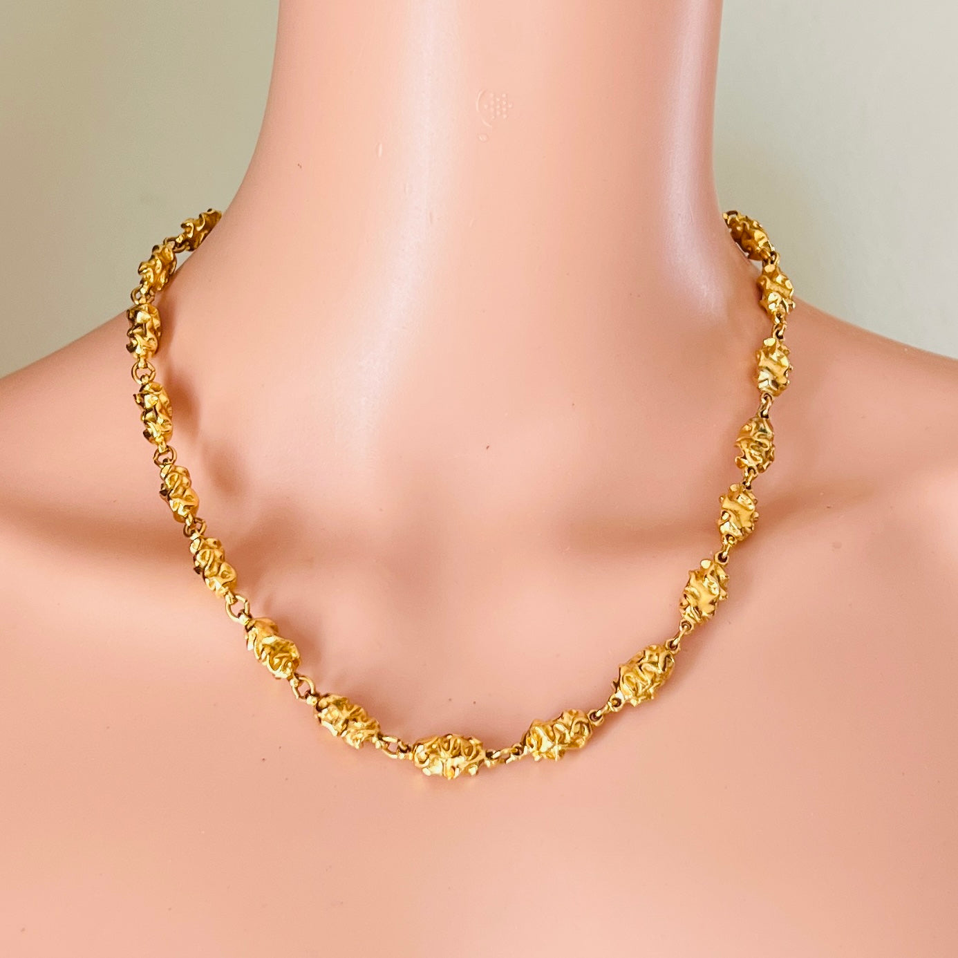 1980s Trifari gold necklace worn on mannequin bold chain style