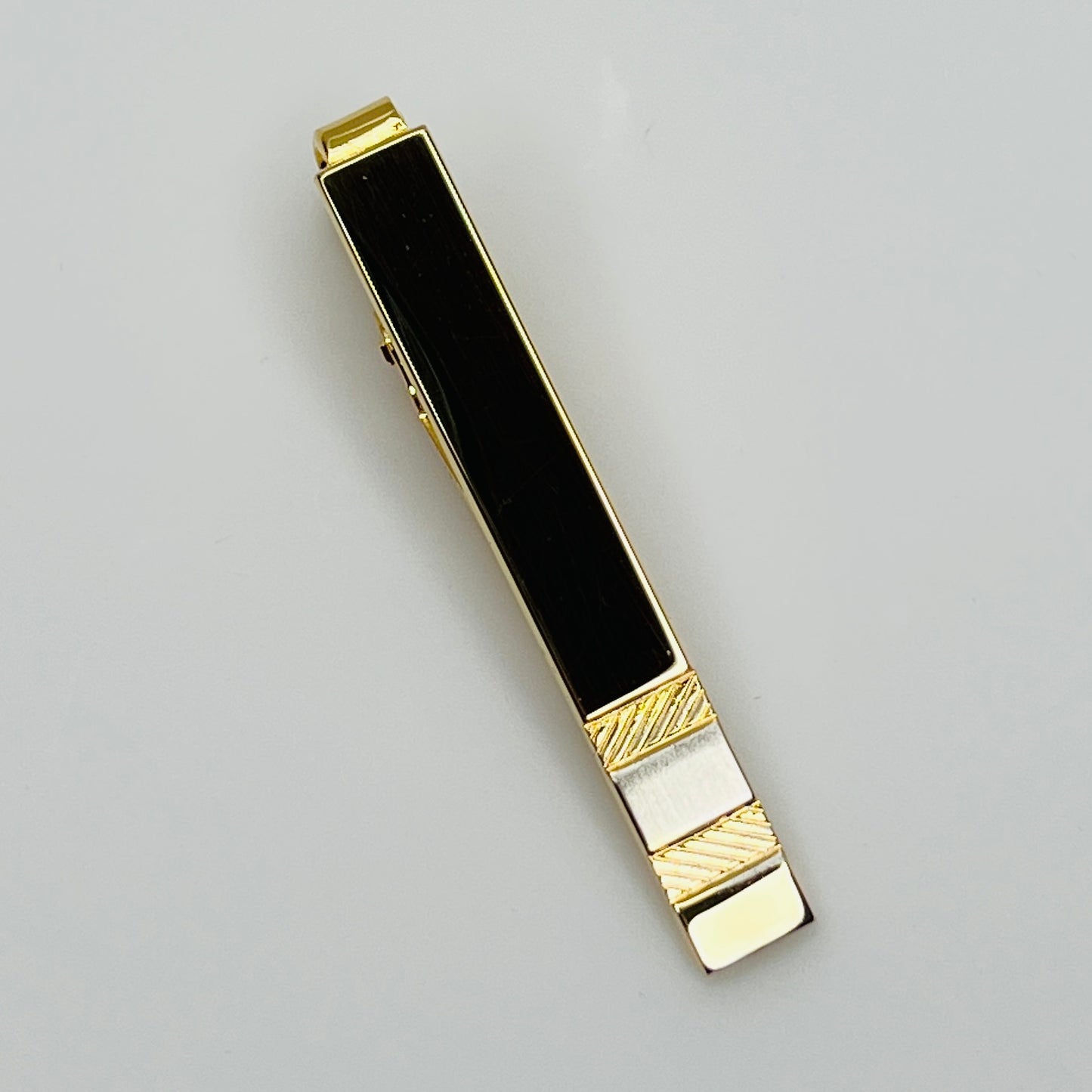 Mid-century gold and silver tone tie clip with minimalist stripe accents
