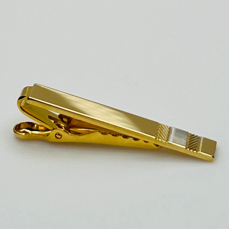 Mid-century gold and silver tone tie clip with minimalist stripe accents