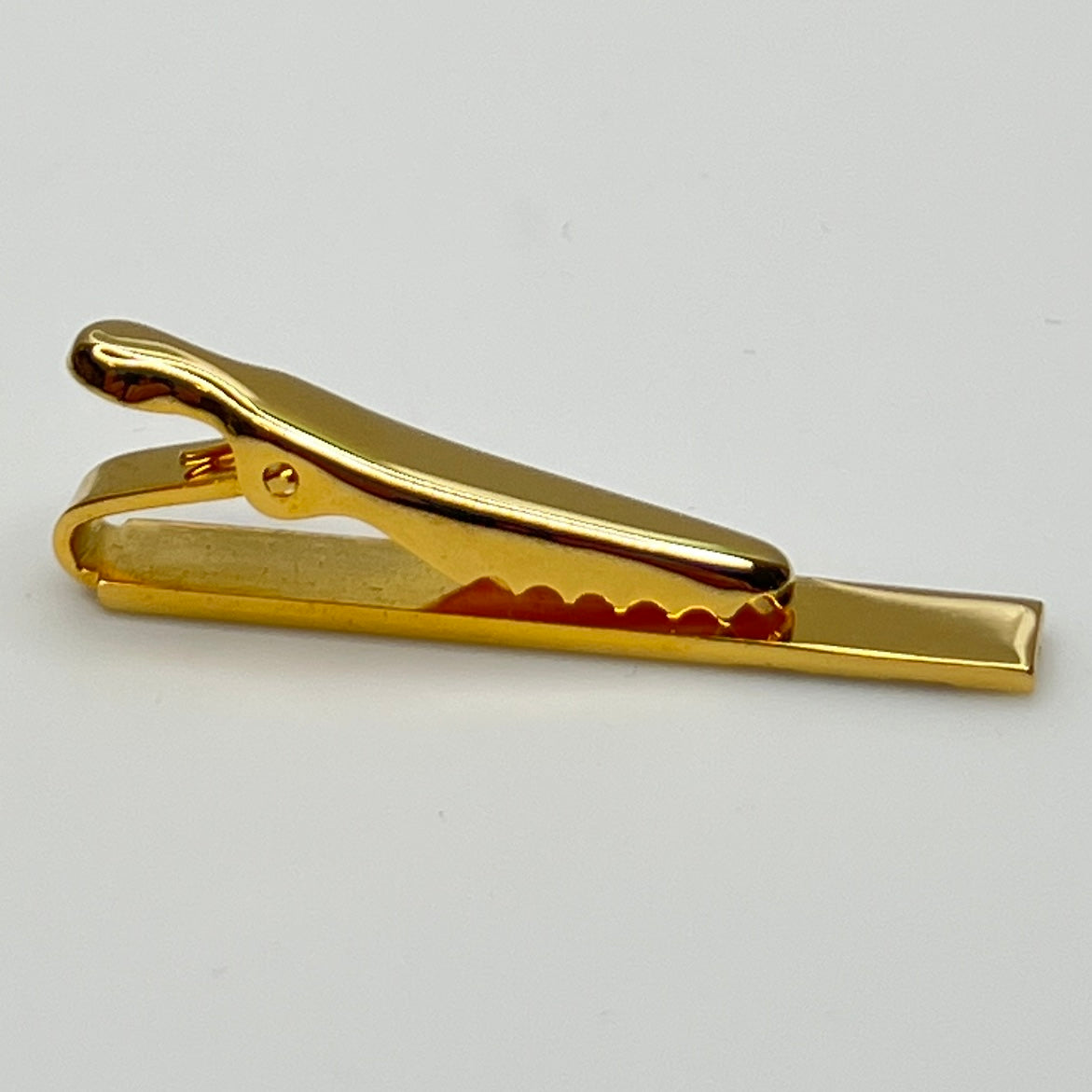 Mid-century gold and silver tone tie clip with minimalist stripe accents