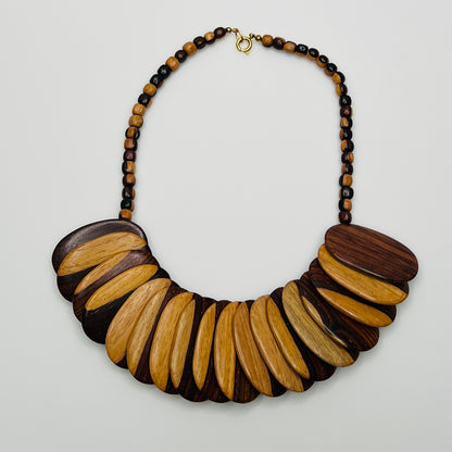 Close-up of alternating light and dark wood beads with natural grain