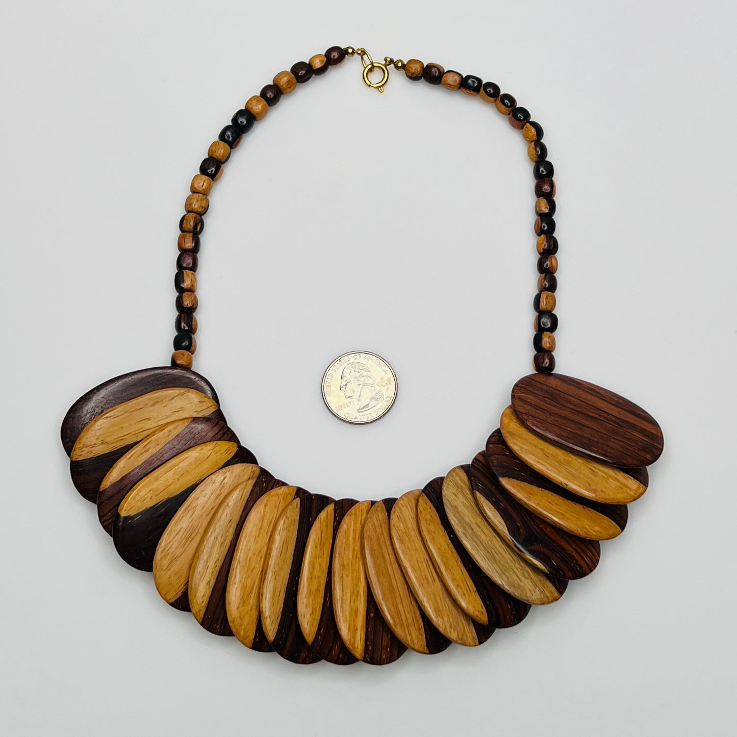 Close-up of alternating light and dark wood beads with natural grain