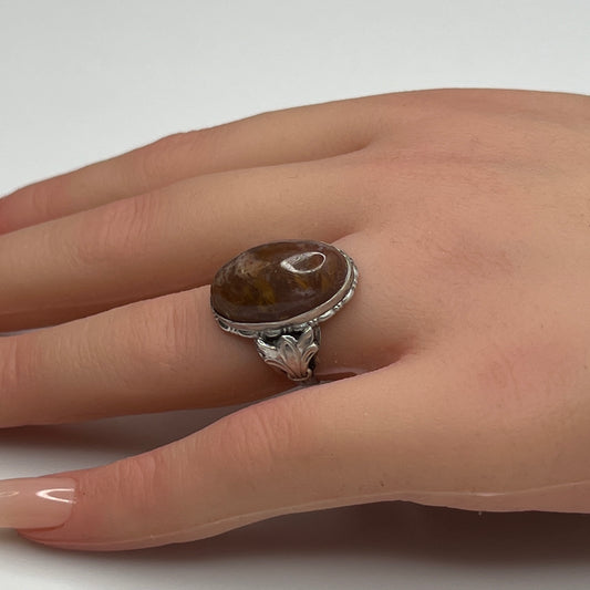 Model wearing sterling silver Uncas ring with large brown agate cabochon