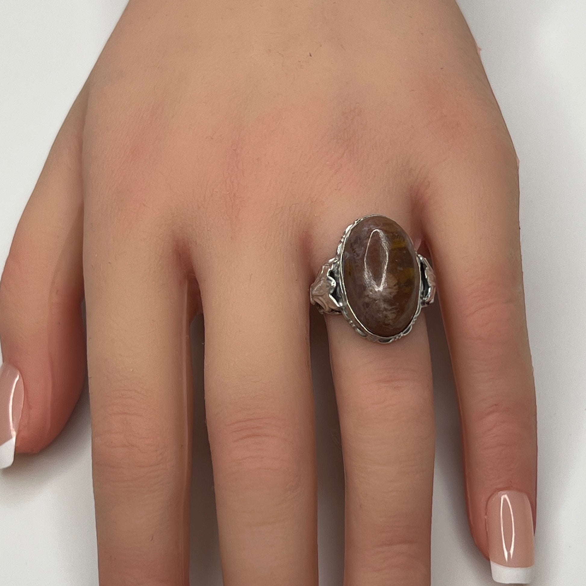 Model wearing sterling silver Uncas ring with large brown agate cabochon