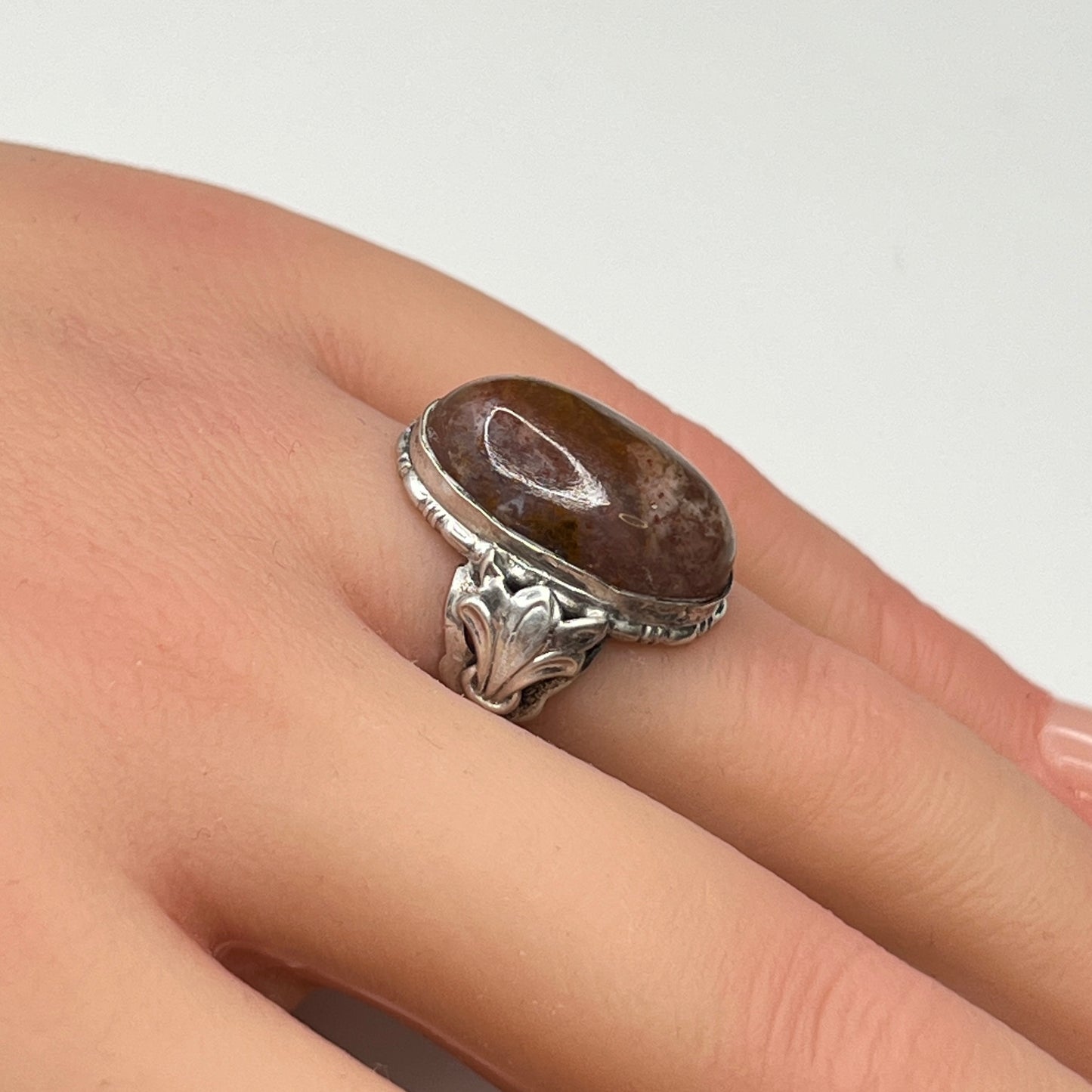 Model wearing sterling silver Uncas ring with large brown agate cabochon