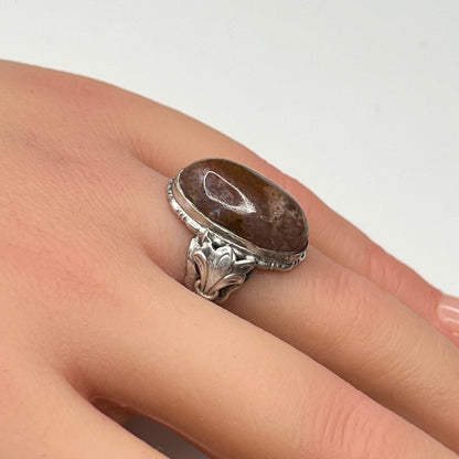 Model wearing sterling silver Uncas ring with large brown agate cabochon