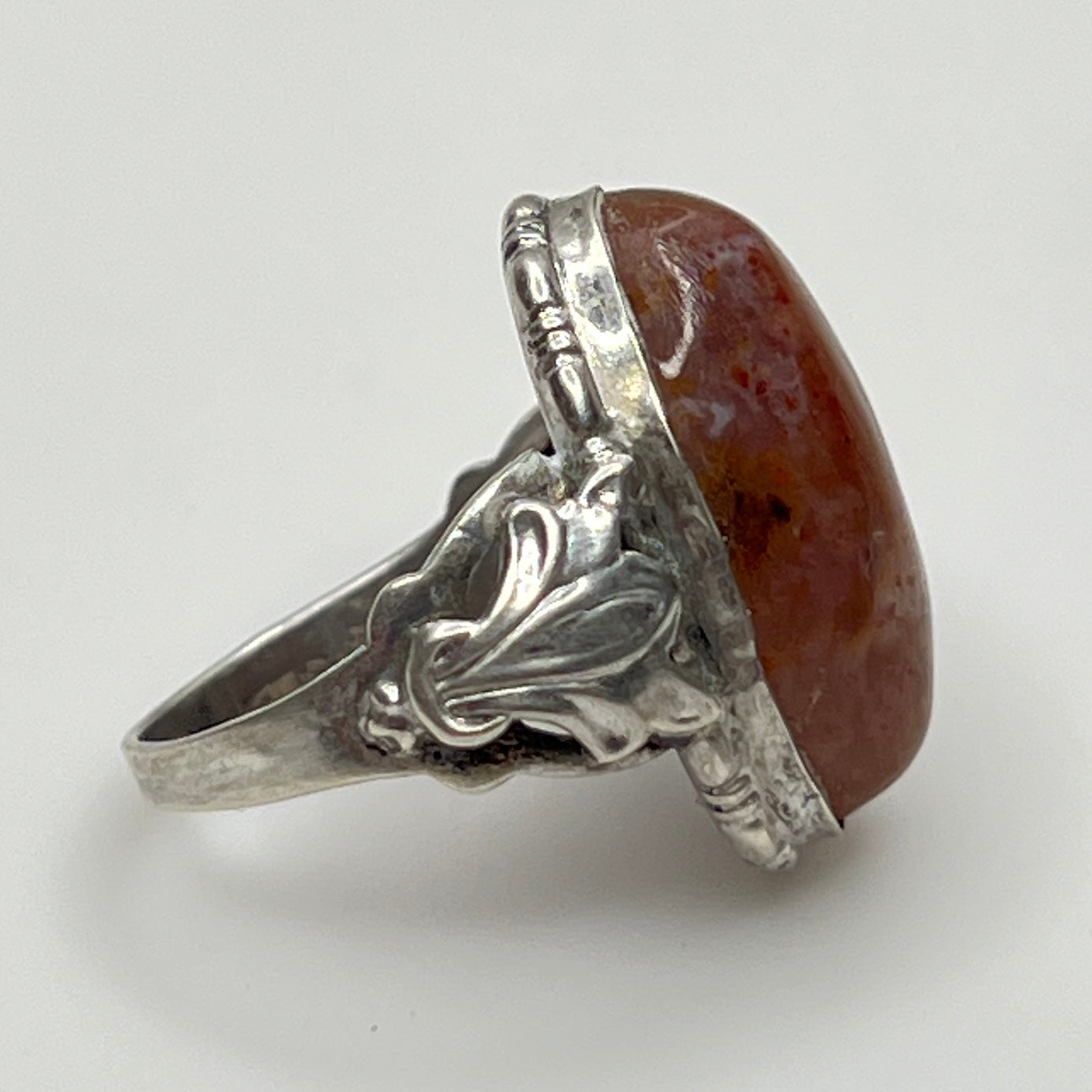 Side profile showing ornate sterling shoulders and bezel-set stone