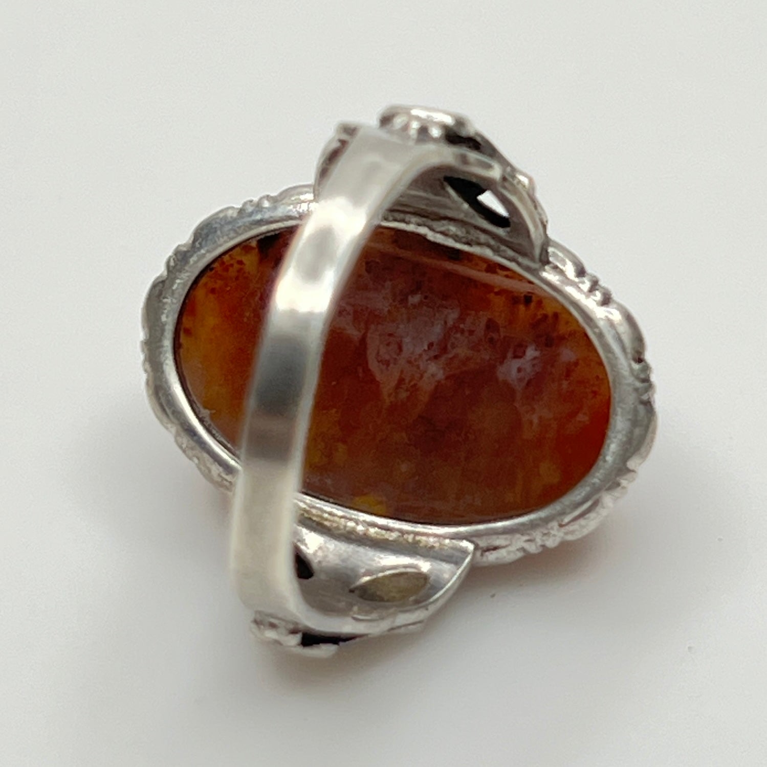 Back profile showing ornate sterling shoulders and bezel-set stone
