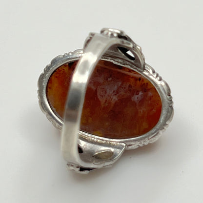 Back profile showing ornate sterling shoulders and bezel-set stone