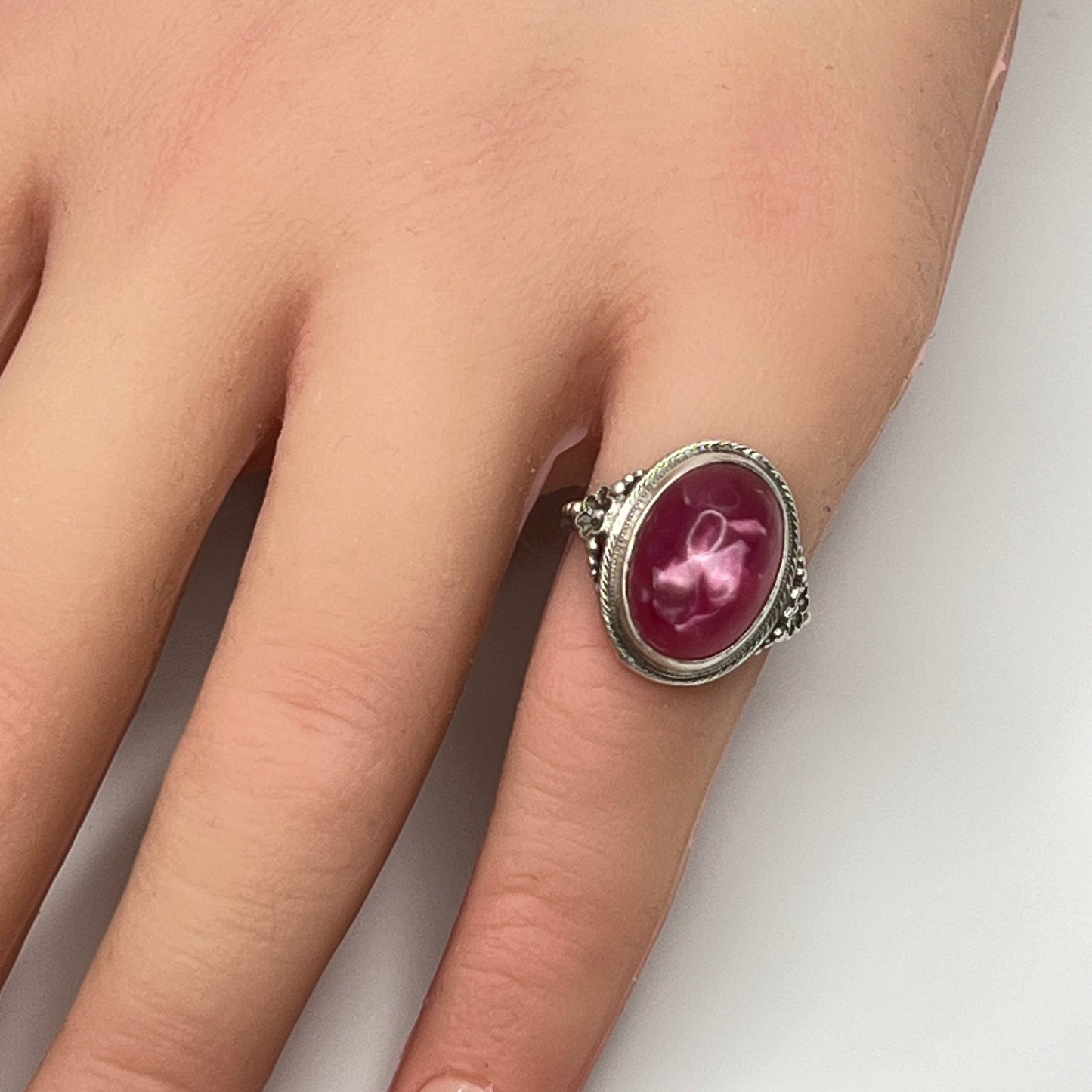 Sterling silver Uncas ring with fuchsia pink cabochon on hand