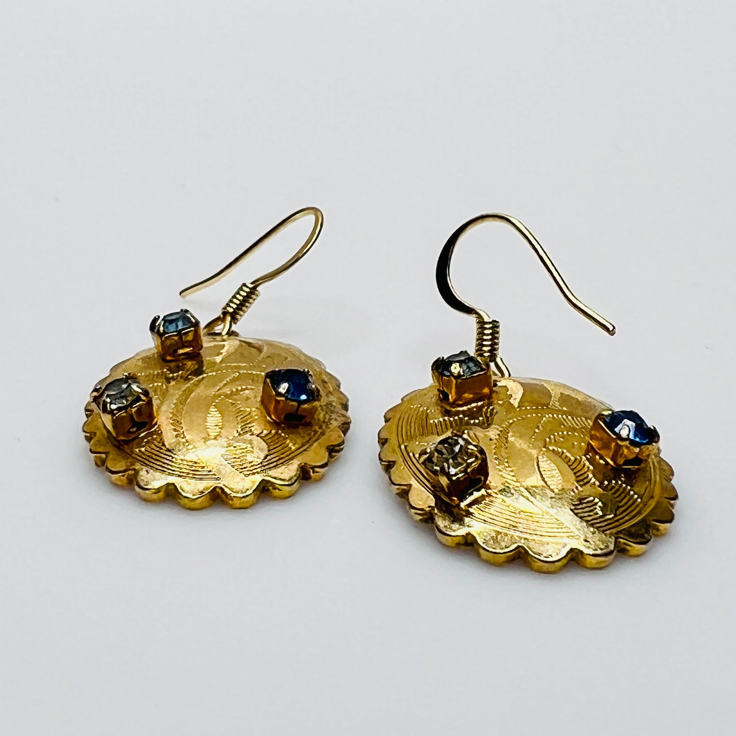 Gold-tone vintage dangle earrings with blue and clear rhinestones, ornate etched design