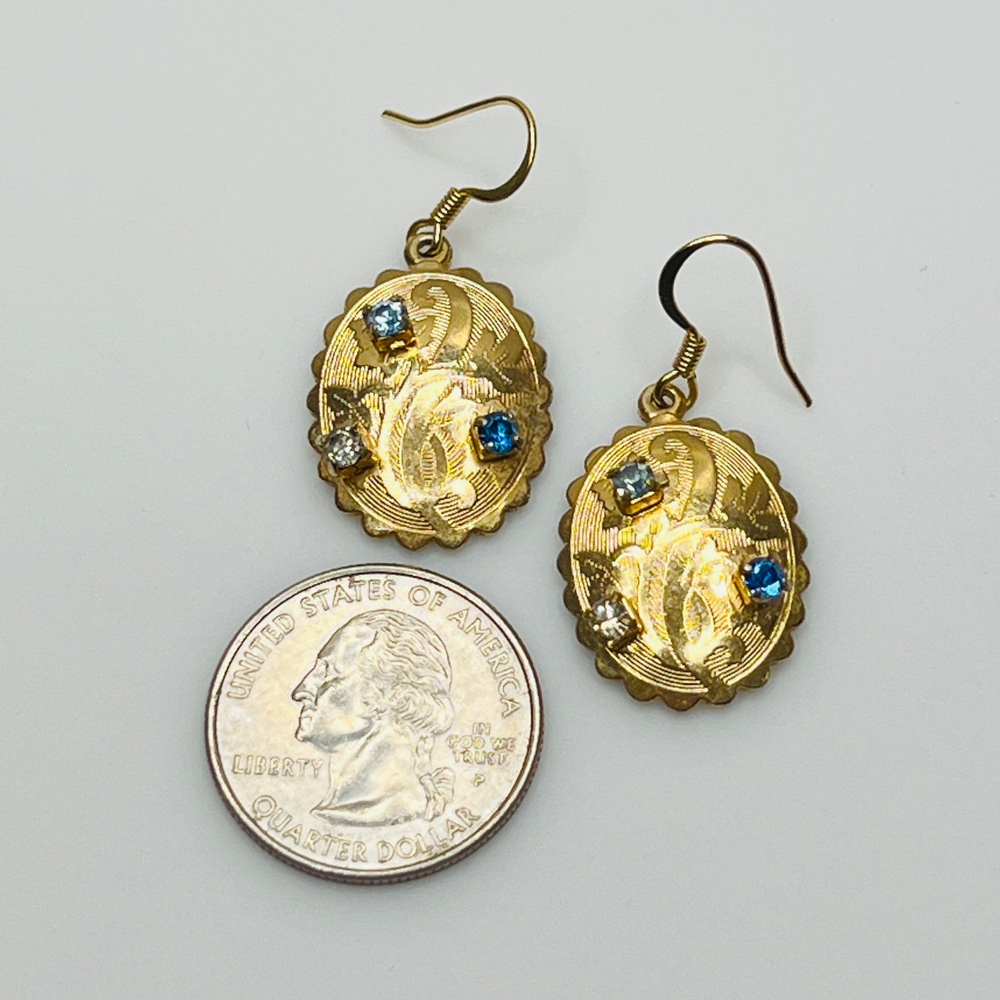 Gold-tone vintage dangle earrings with blue and clear rhinestones, ornate etched design