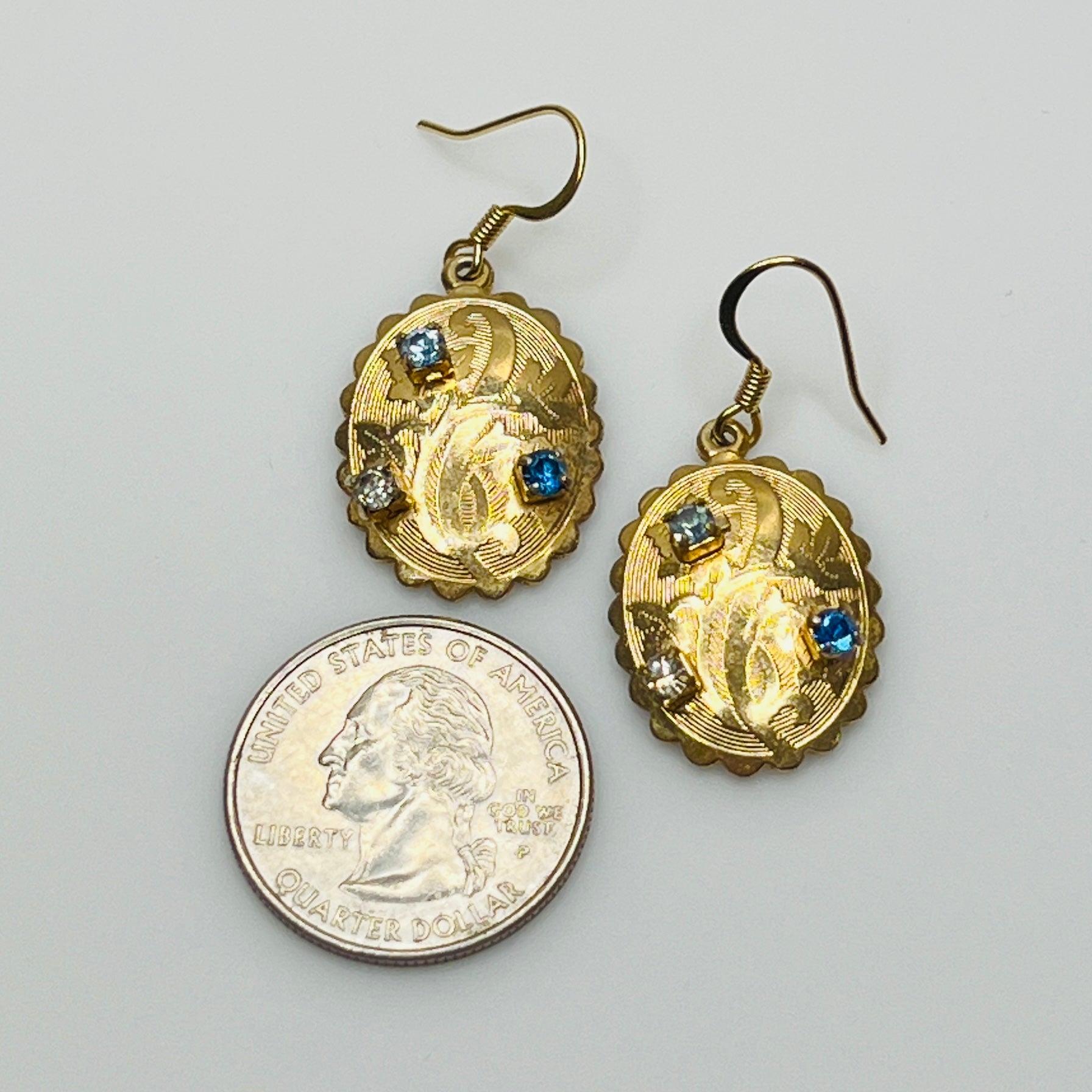 Gold-tone vintage dangle earrings with blue and clear rhinestones, ornate etched design